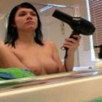 Sublime brunette exgirlfriend Andi showing off her amazing breasts in the bathroom mirror